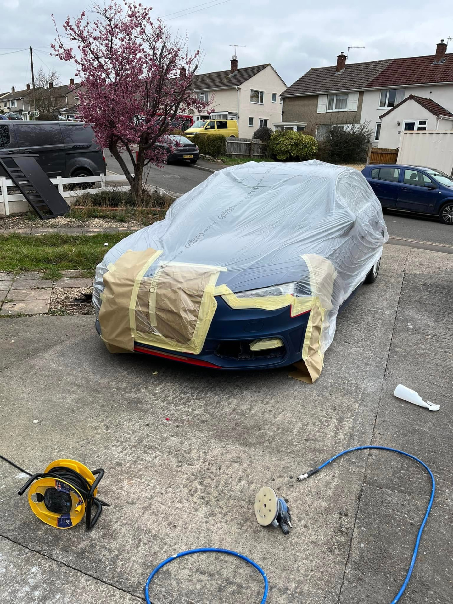 Blue car masked and covered for paint preparation by SR Bodyworx